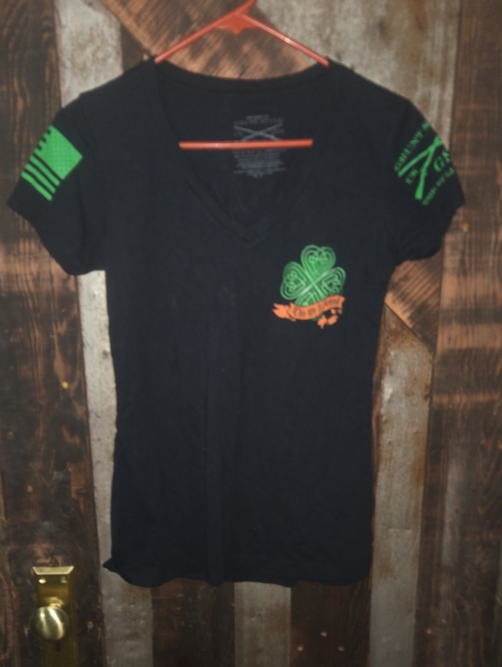 Grunt Style Black V‑Neck Tee with Green Clover and Orange Banner